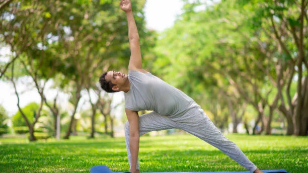 Person doing yoga outdoors - healthy lifestyle transformation